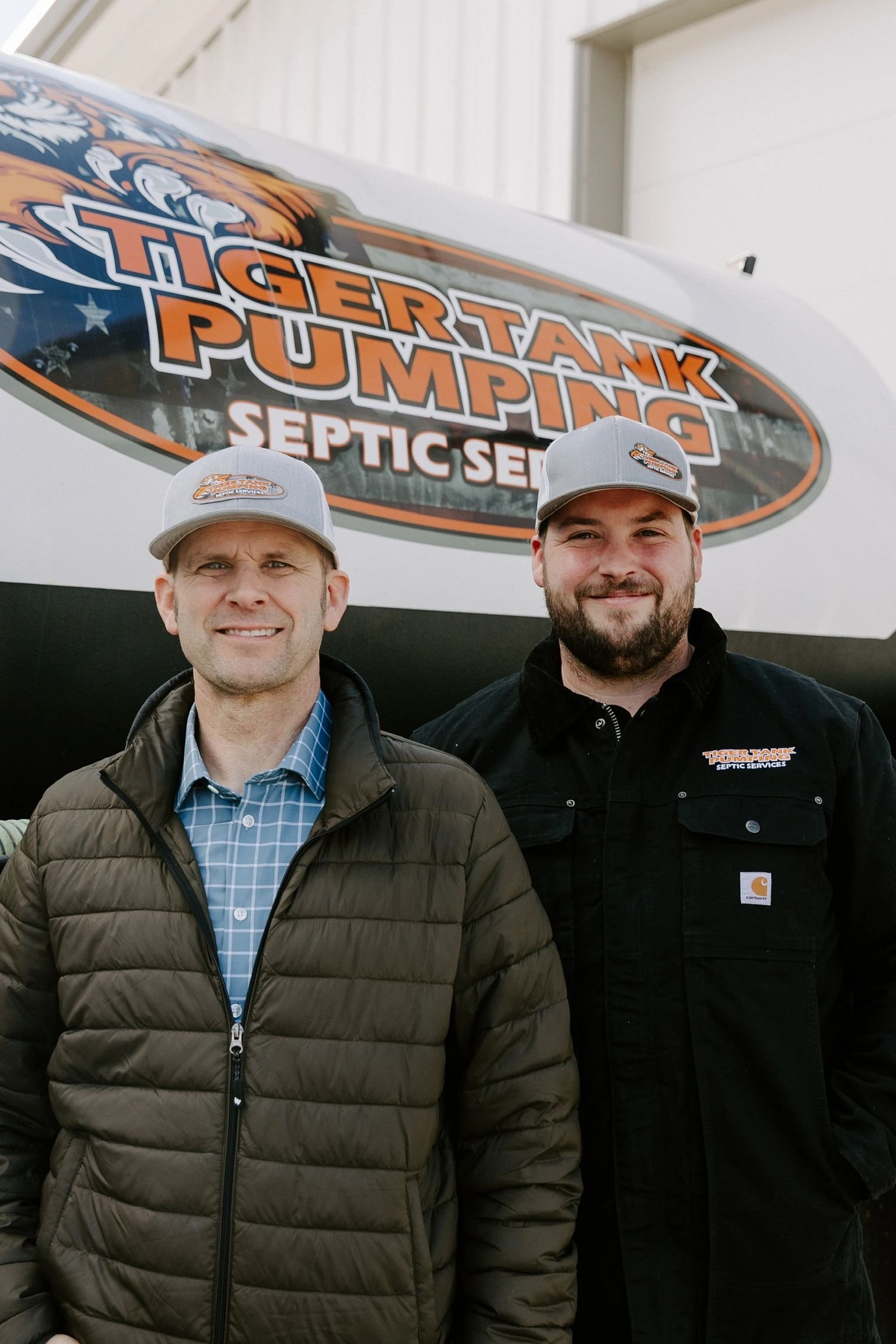 Michael Yeates and Tim Yeates in front of a Tiger Tank Pumping truck.